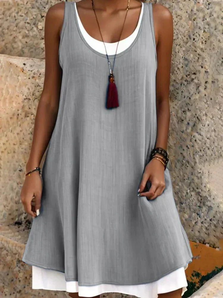 Stylish women's sleeveless mini dress, featuring a chic layered design and round neck for summer fashion.
