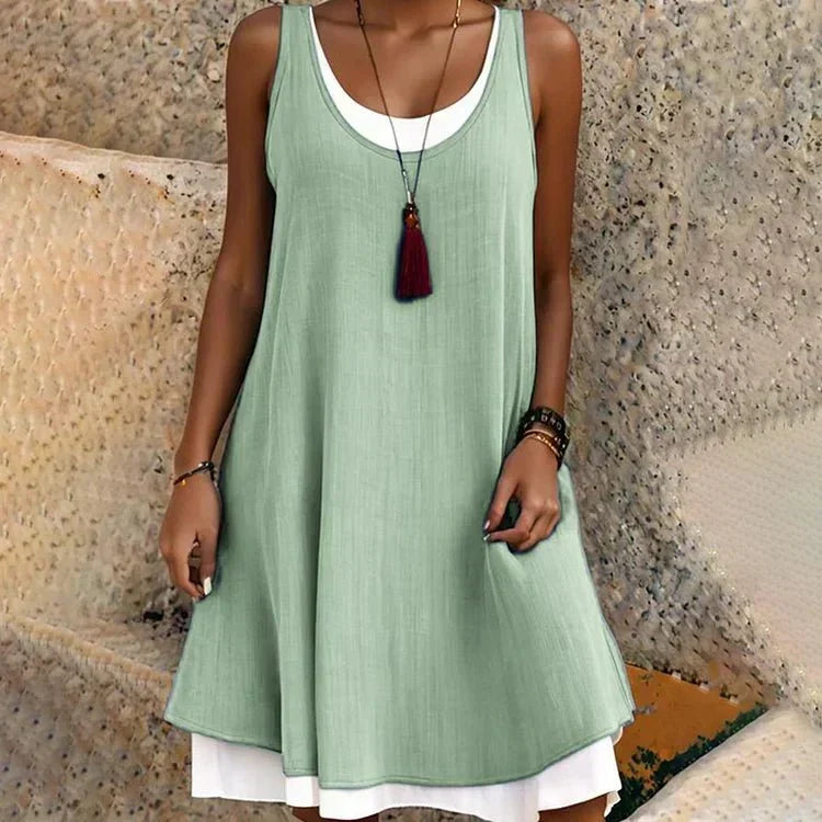 Women's summer layered sleeveless mini dress. Chic round neck casual daywear, a versatile fashion piece.