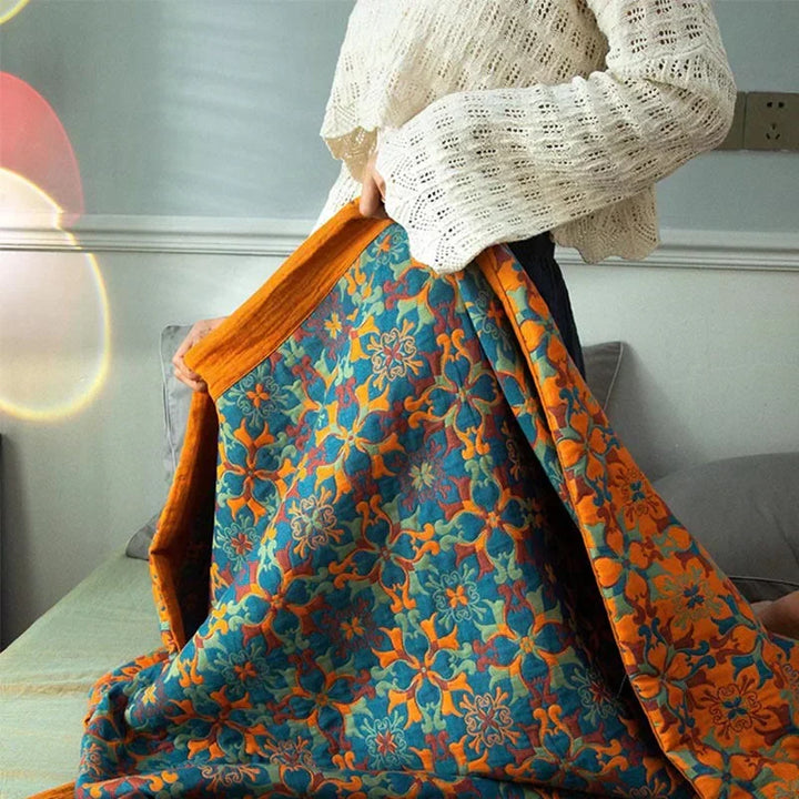 Comfortable orange & blue patterned six-layer cotton quilt, enhancing any bedroom's home decor.