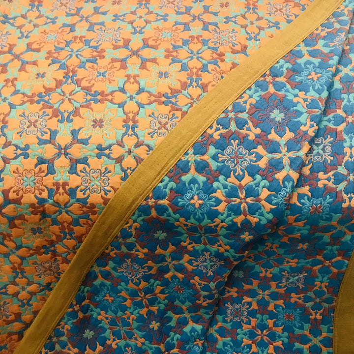 Eco-friendly six-layer cotton quilt, vibrant orange & blue pattern. Soft, comfortable bedding for home.