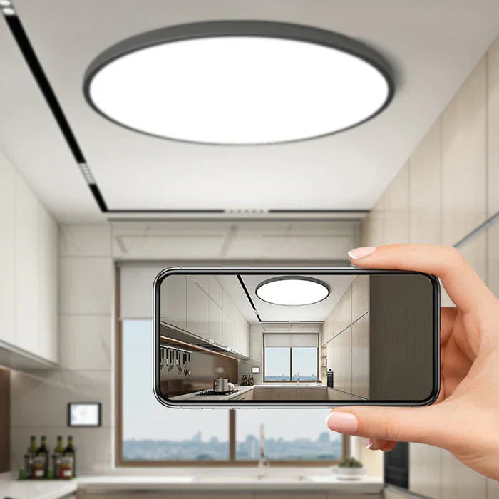 The OrbGlow LED ceiling light casting a warm, ambient glow in a bedroom.
