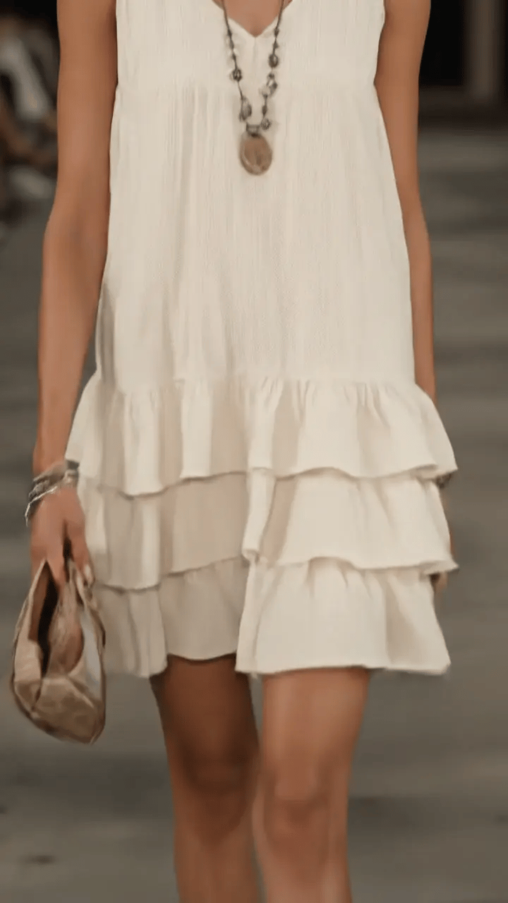Comfortable sleeveless V-neck tunic dress for women, featuring a chic ruffle hem. Ideal for casual summer days.