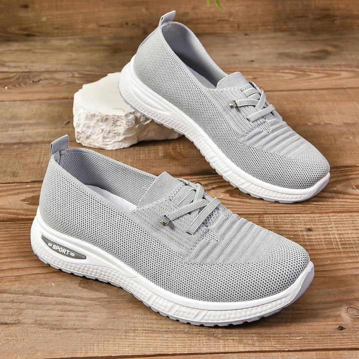 Slip-on gray women's orthopedic walking shoes, breathable, with arch support & ultimate cushioned comfort.
