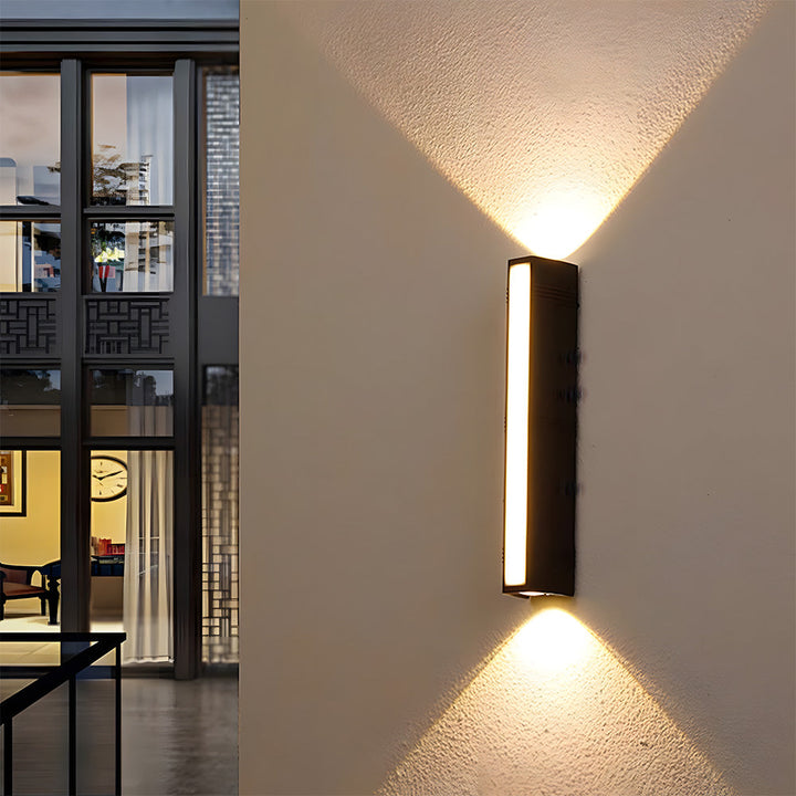 Durable, waterproof black LED wall sconce for contemporary exterior lighting.