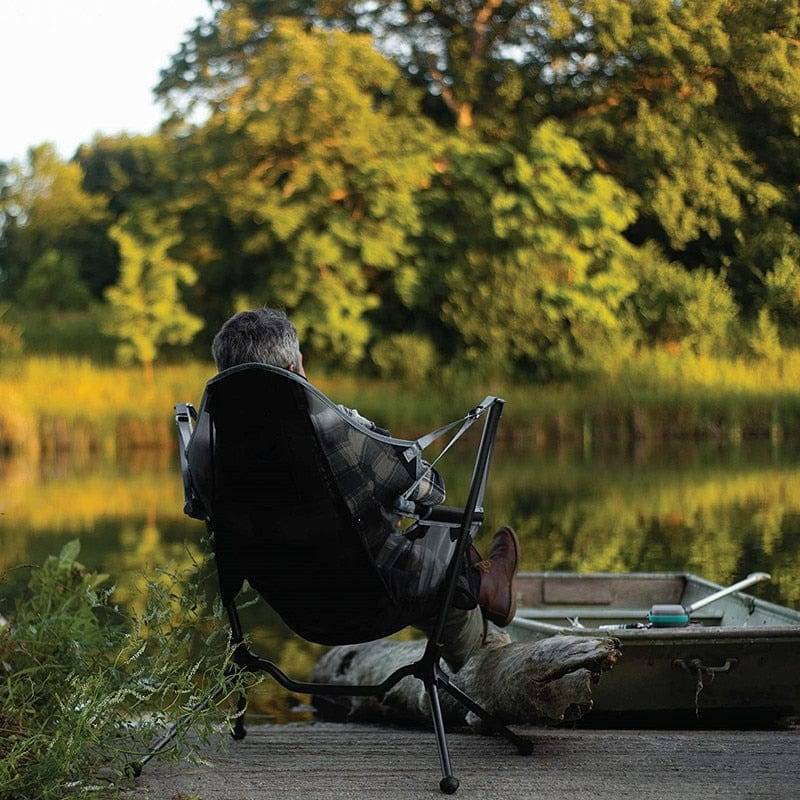 Compact folding outdoor chair, offers rocking comfort for camping & patio use.
