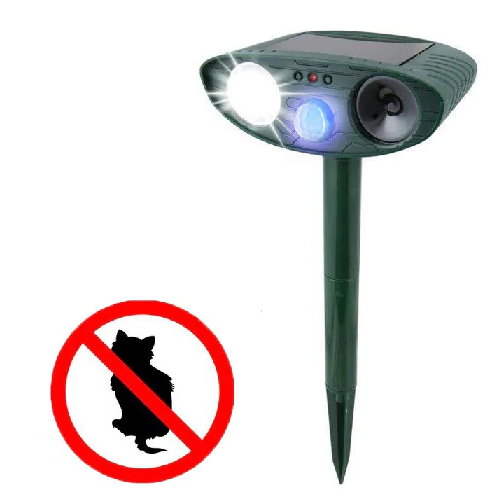 Solar ultrasonic cat deterrent device staked in a green garden bed, offering yard protection.