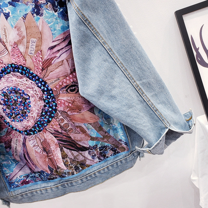 Stylish women's oversized denim jacket with a unique graphic back print. Essential trendy outerwear for modern casual wear.