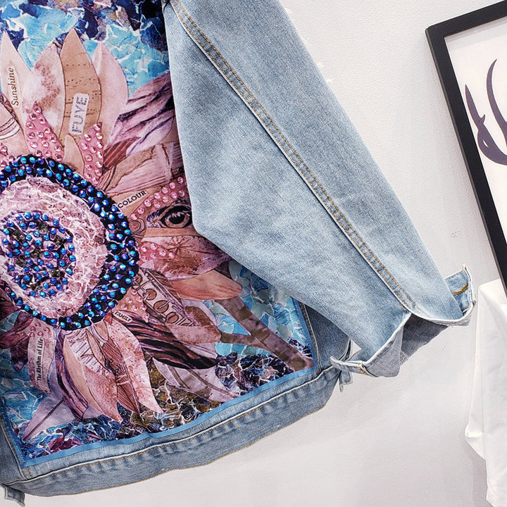 Stylish women's oversized denim jacket with a unique graphic back print. Essential trendy outerwear for modern casual wear.