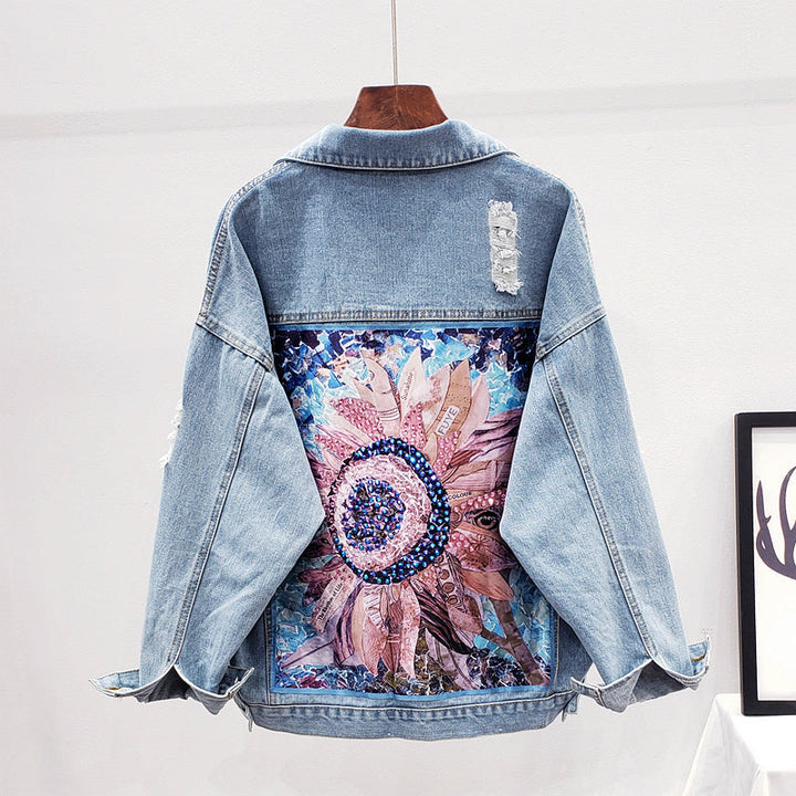 Women's oversized denim jacket, light wash, with a unique artistic print on the back. Perfect for street style.