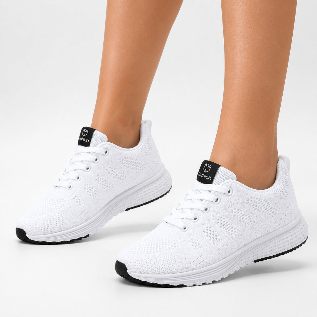Close-up of flexible knit material on women's ultra-light comfort shoes, showcasing texture.