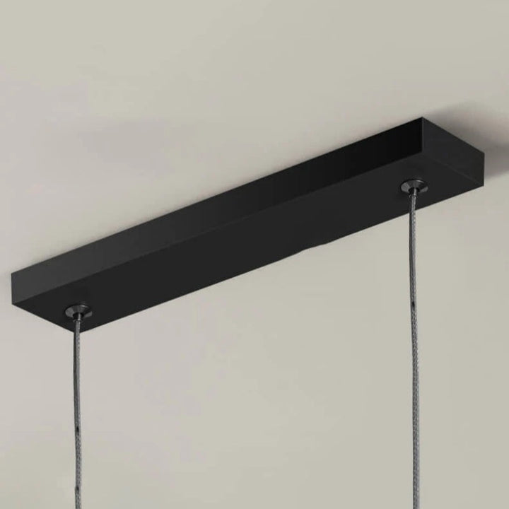 Black and gold Arisha LED chandelier, an adjustable modern light for dining spaces.