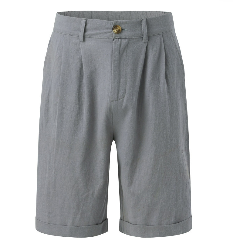 Man in modern tailored pleated shorts, showcasing a refined smart casual style suitable for summer fashion.