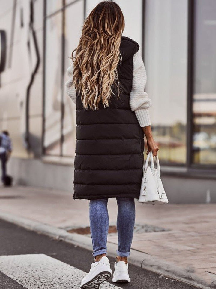Women's long quilted black puffer jacket, providing superior warmth & a chic look for winter adventures.