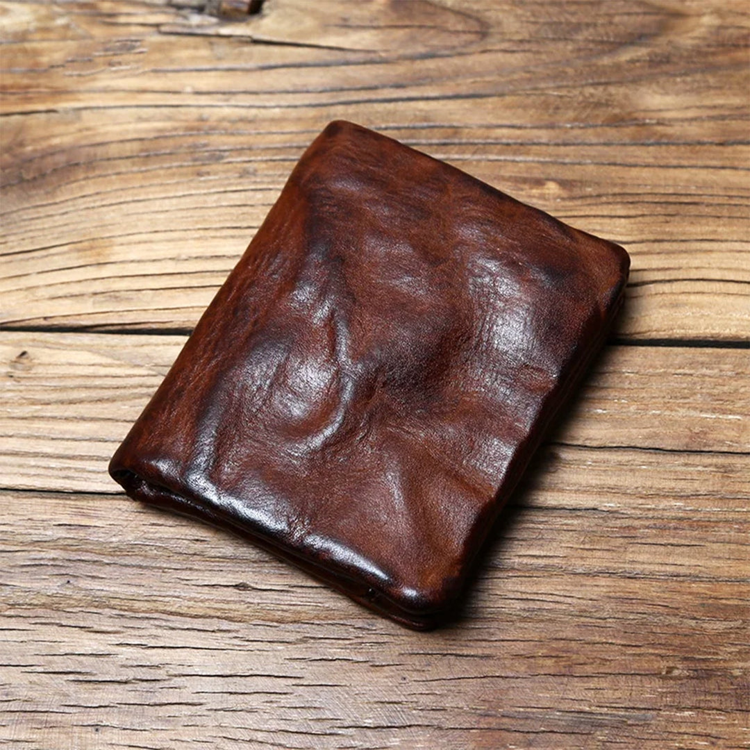 Men's full-grain leather bifold wallet with rich brown patina, offering timeless style & durability.