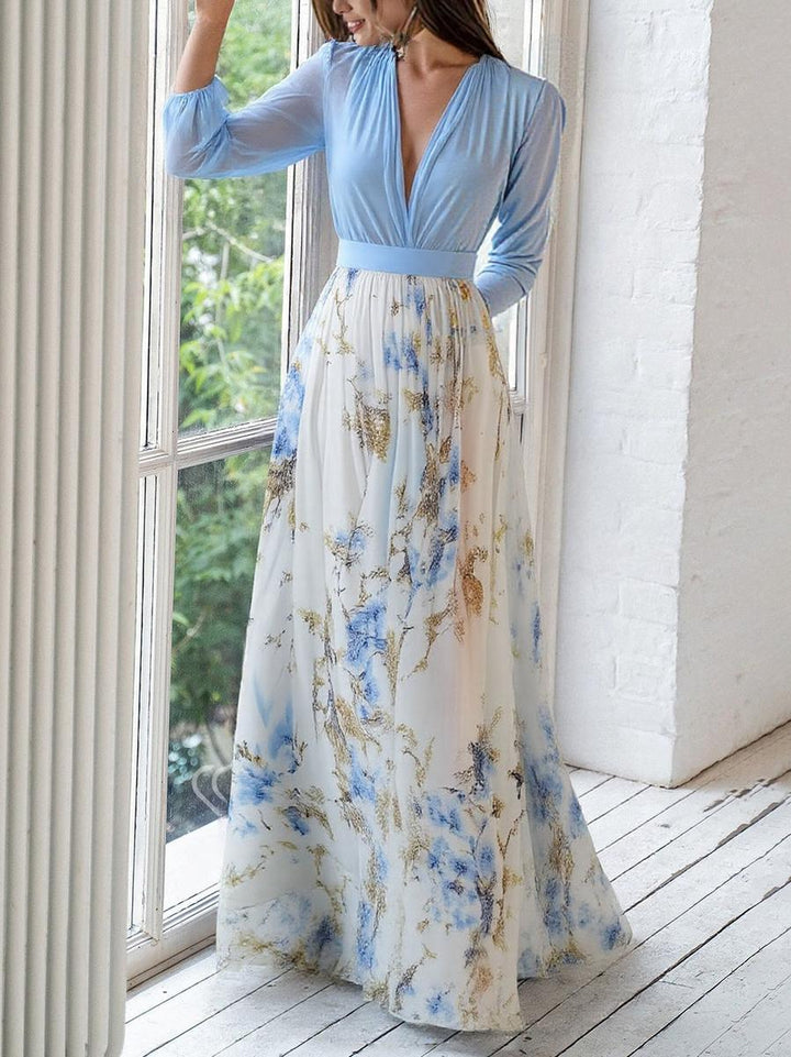 Timeless women's floral maxi dress for special occasions. Features a belted waist, long sleeve, & flowing skirt.