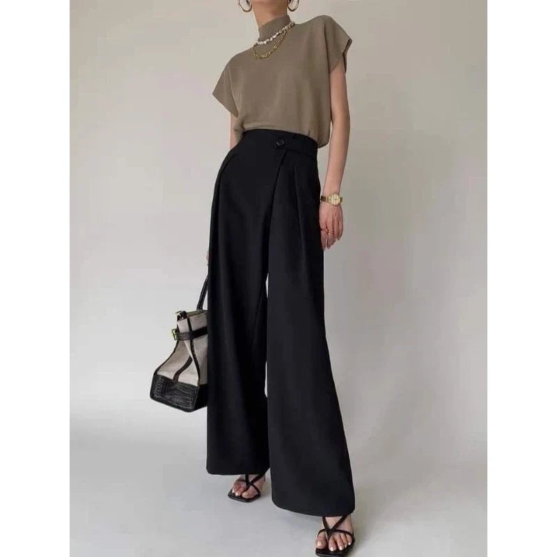 Modern statement top for women: Sleeveless mock neck with bold padded shoulders.