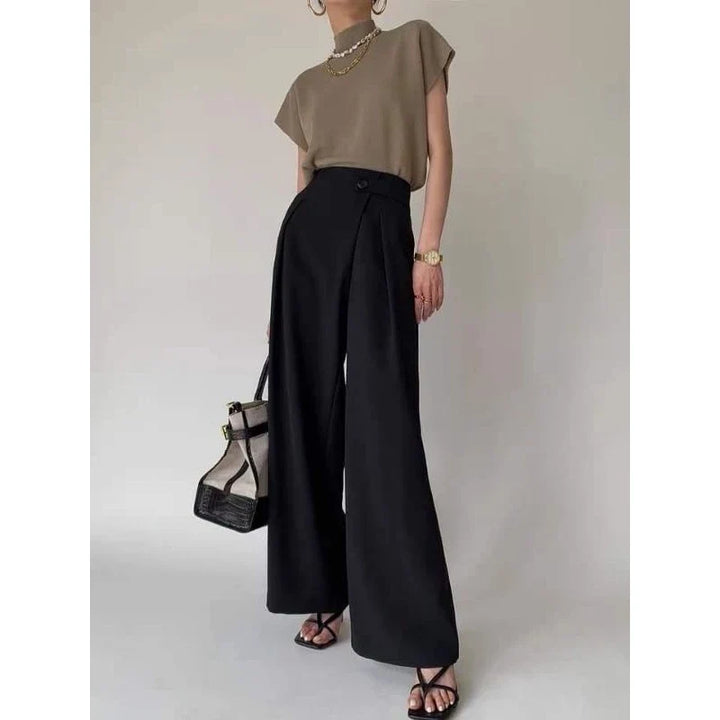 Modern statement top for women: Sleeveless mock neck with bold padded shoulders.