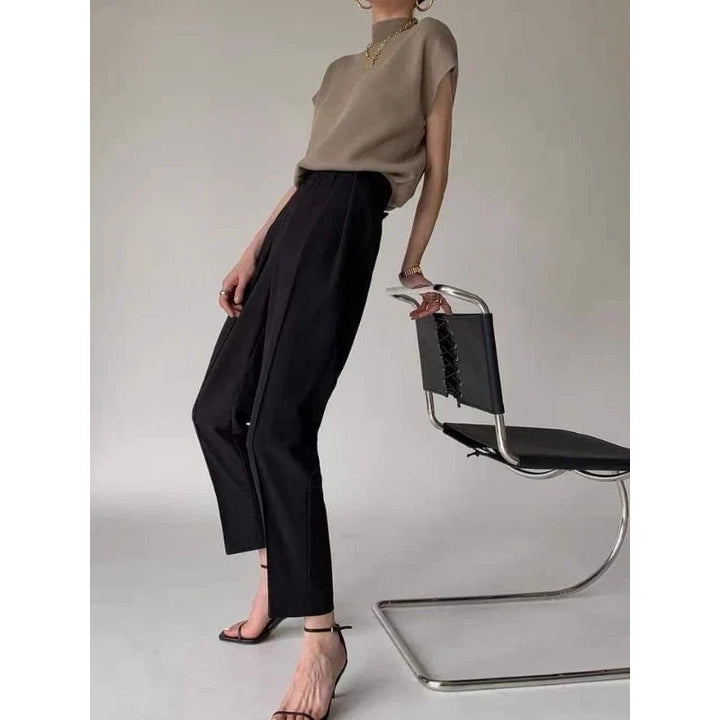 Professional yet chic women's top: Sleeveless, mock neck, and subtly padded shoulders.