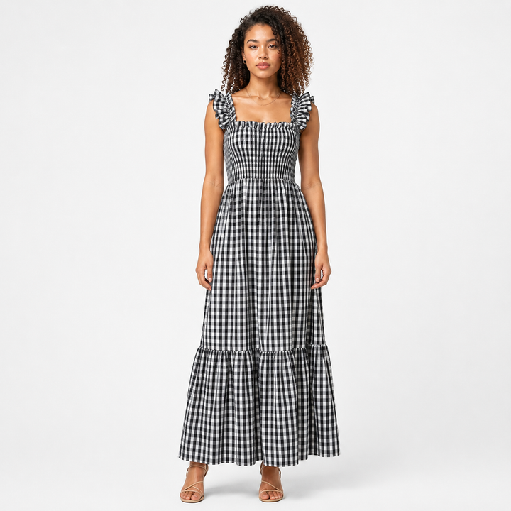 Front view of women's chic gingham maxi dress with ruffle straps and smocked bodice. Summer fashion.