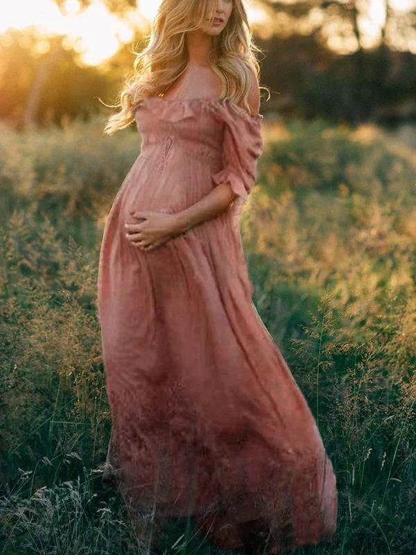 Elegant pinkish red off-shoulder maxi dress for maternity. Comfortable pregnancy fashion for special occasions.