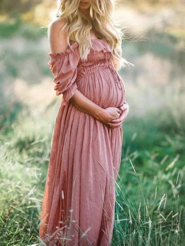 Women's pinkish red flowy off-shoulder maxi maternity dress, ideal for elegant summer or special occasion wear.
