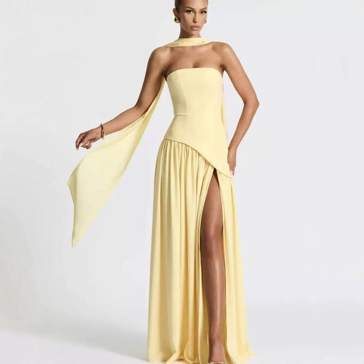 Elegant strapless formal maxi dress, features a flowing pleated skirt and a chic high slit, special occasion ready.