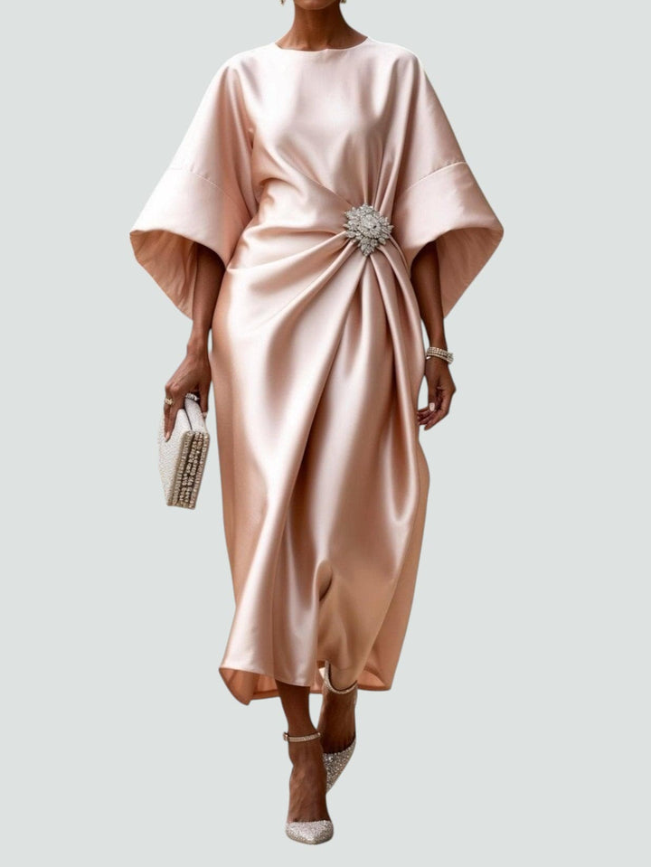 Front view of a graceful women's draped cocktail dress in shimmering satin-look fabric for evening events.