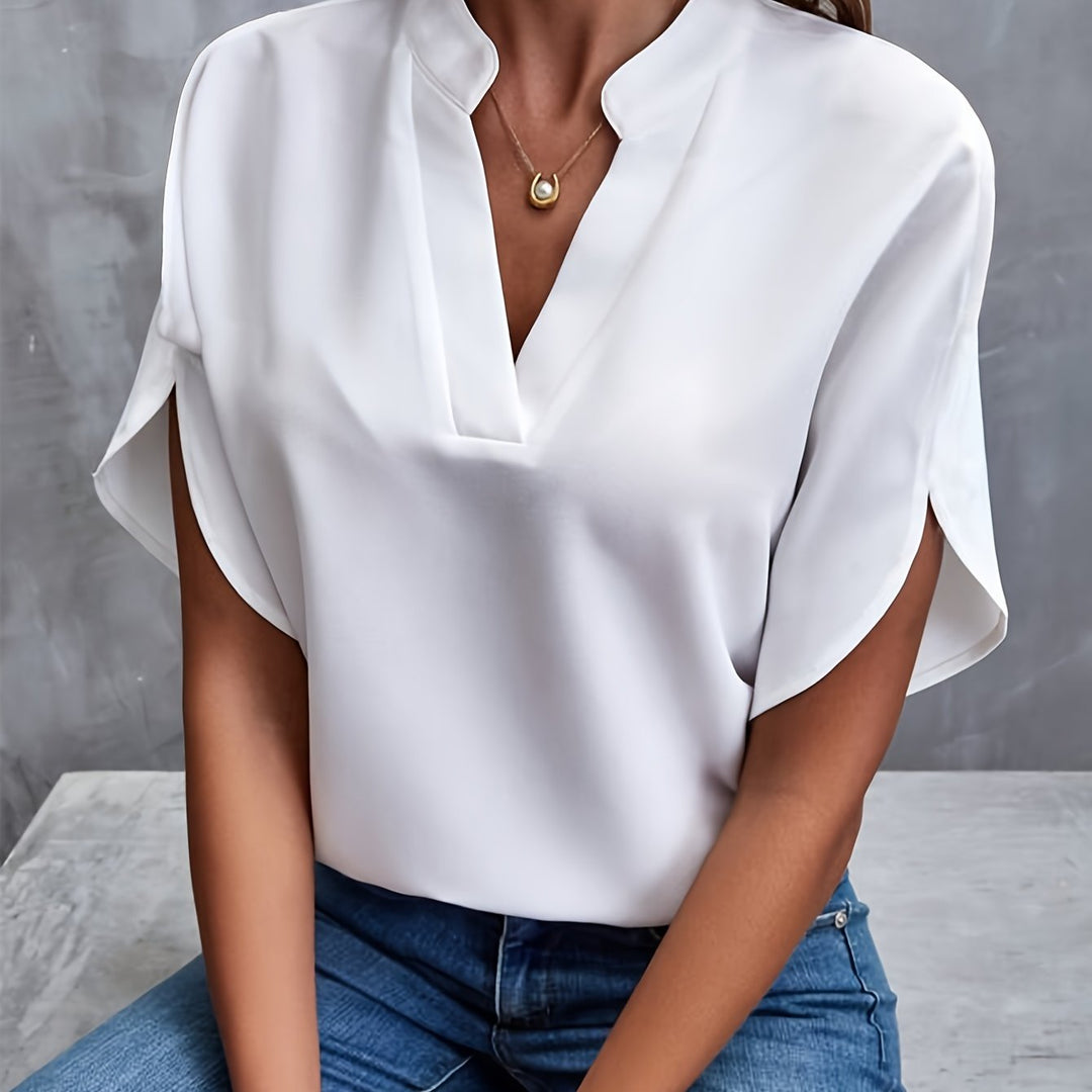 Women's timeless v-neck blouse with flowing batwing sleeves, elegant & versatile for office or casual wear.