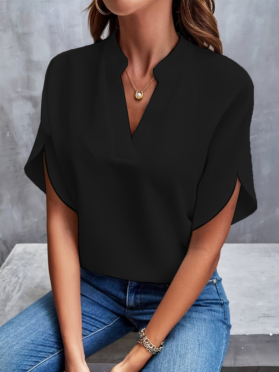 Timeless women's v-neck batwing blouse, flowing fabric for a relaxed yet stylish office or casual look.