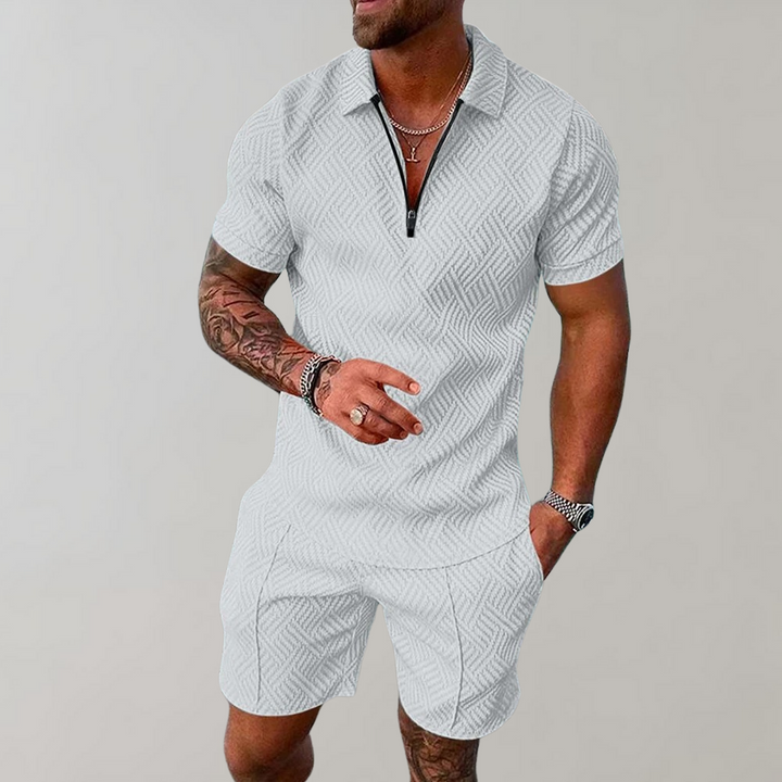 Full body shot of a men's stylish summer outfit: comfortable polo shirt and versatile shorts for casual or smart casual wear.