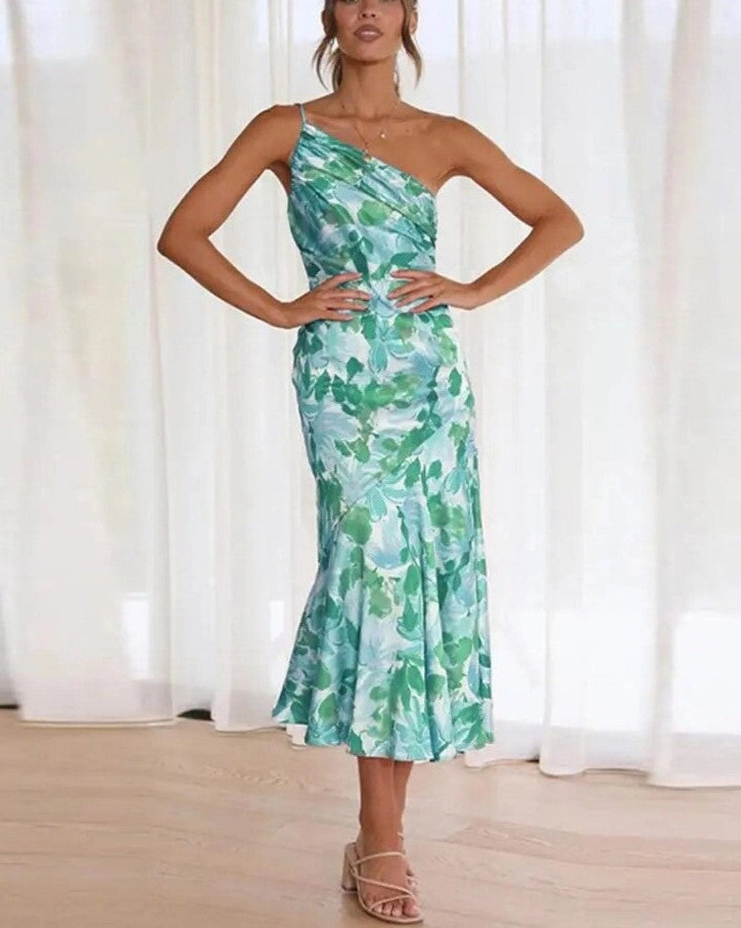 Fashionable women's asymmetric floral print midi dress, one-shoulder design, elegant for party or occasion wear.