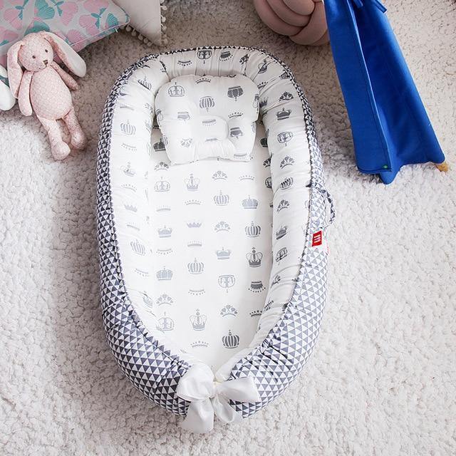Portable baby snuggle nest & lounger for safe infant sleep & travel. Soft, cozy newborn sleeper, a nursery essential.