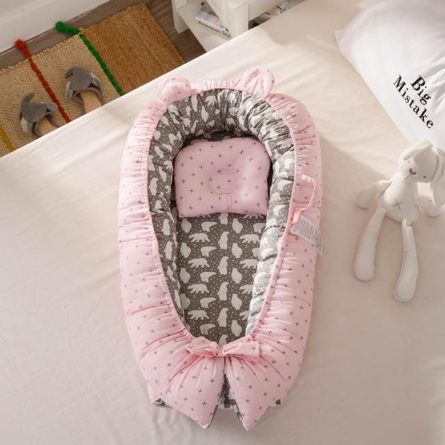 Snuggly portable infant nest and baby bed. A cozy newborn sleeper and lounger for safe, comfortable baby time. Nursery.