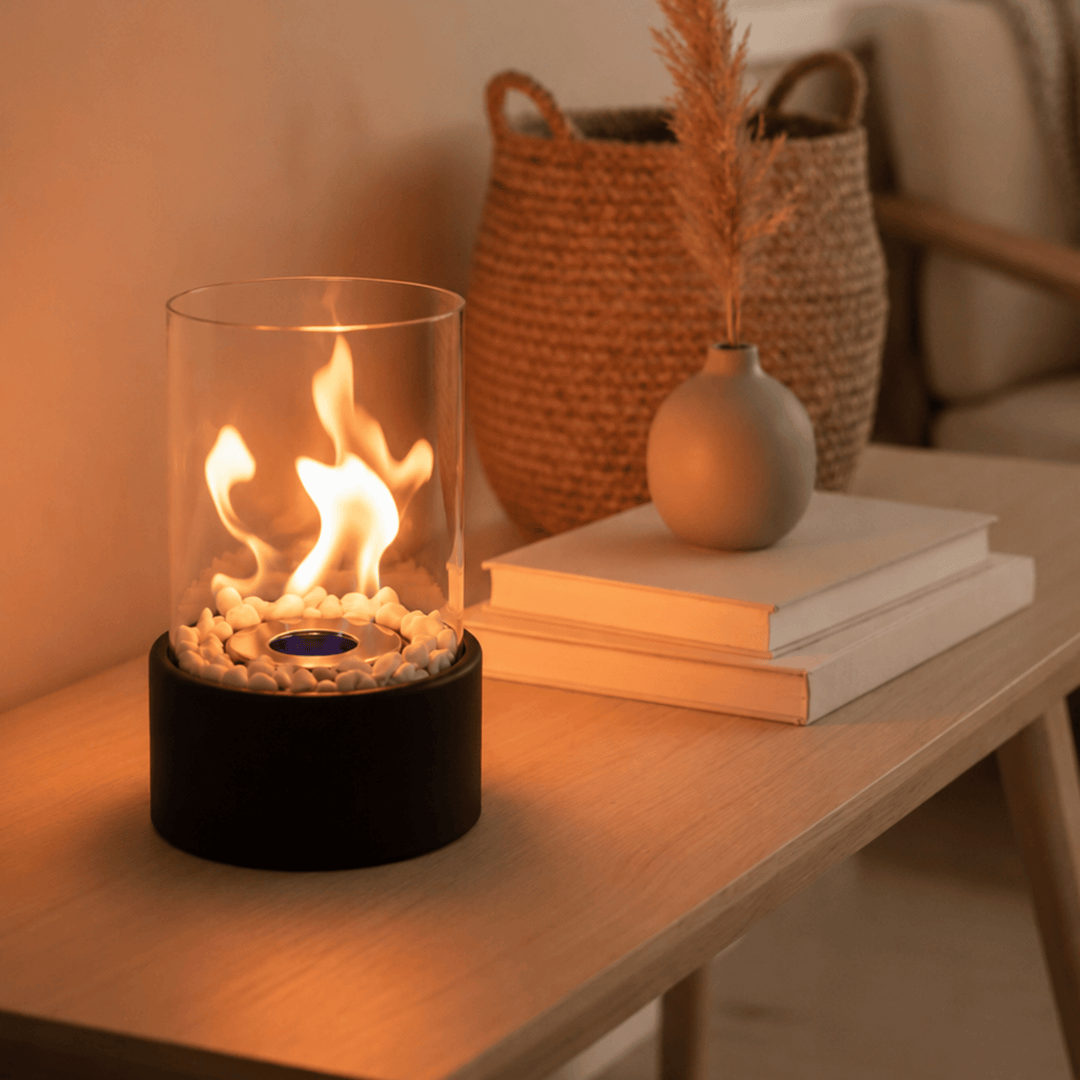 Compact portable glass fireplace, ideal indoor/outdoor tabletop decor, runs on clean ethanol fuel.