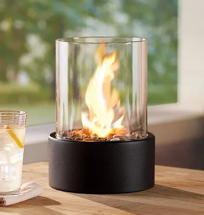 Stylish steel & glass table fire lantern, perfect for indoor decor or outdoor patio ambiance.