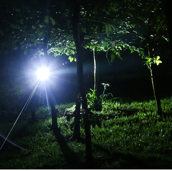 Tactical LED headlamp, waterproof, rechargeable battery, offers bright focused light for night use.