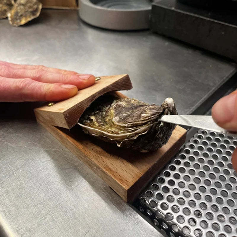 Durable oyster shucker tool with ergonomic wood handle, ideal for effortless seafood prep in any home kitchen.