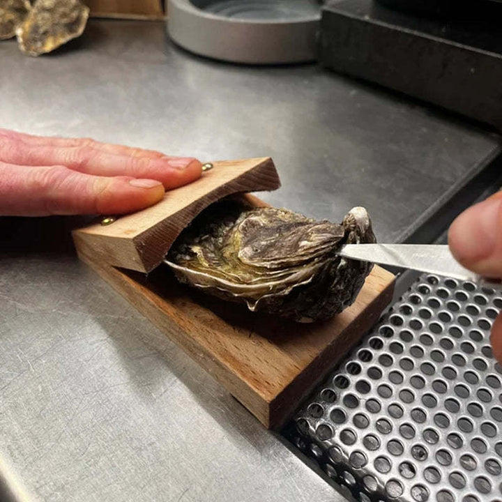 Durable oyster shucker tool with ergonomic wood handle, ideal for effortless seafood prep in any home kitchen.