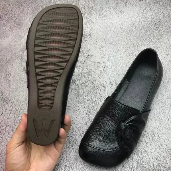 Stylish comfort loafers for women, featuring a subtle wedge heel and embossed design.
