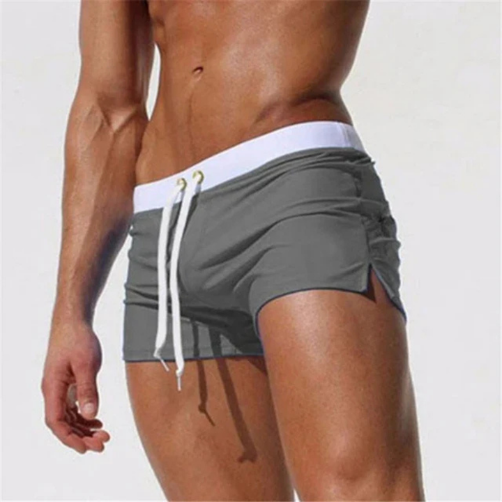Comfortable men's quick-drying swim shorts featuring an adjustable drawstring waist for secure fit & beach activewear.