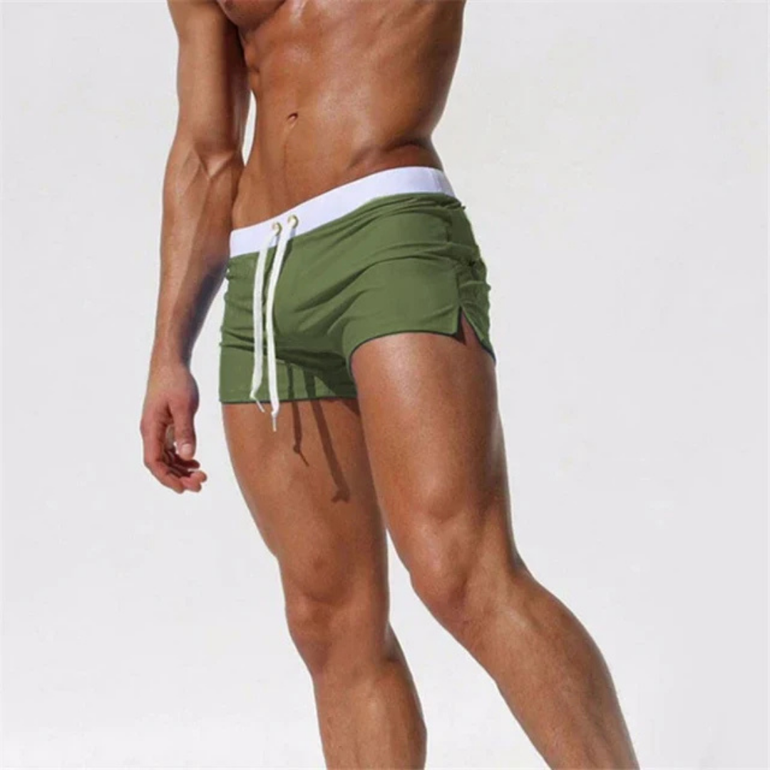 Men's quick-dry swim shorts in a vibrant color, featuring an elastic waistband and adjustable drawstring closure.