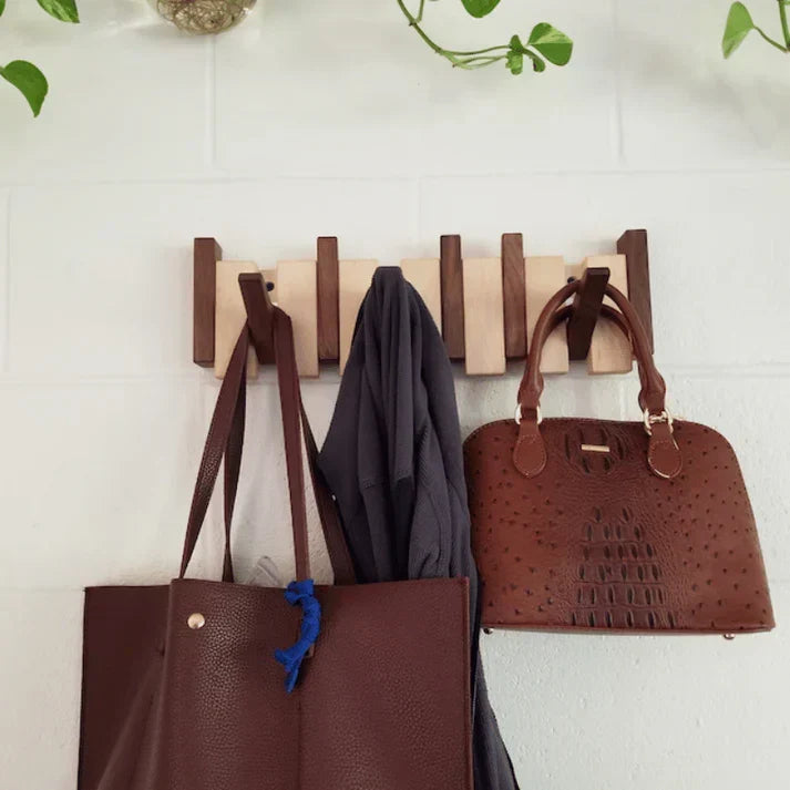 Unique piano key design wall-mounted coat rack. Artistic home decor storage solution for hallways & entryways.