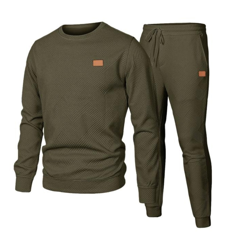 Model wearing a men's 2-piece crew neck tracksuit set with joggers. Perfect for everyday style.