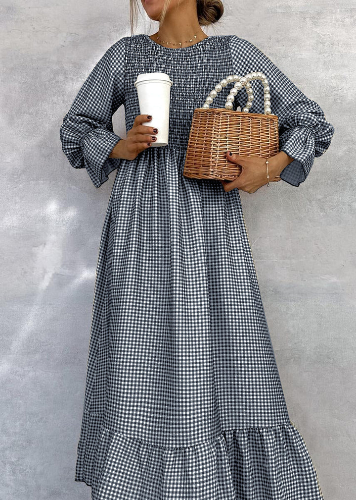 Chic women's smocked gingham maxi dress with long sleeves and an A-line cut, perfect for day-to-night elegance.