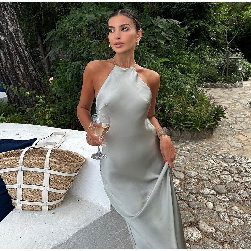 Elegant women's halter neck maxi dress, perfect for formal events & evening wear. Timeless sleeveless design.