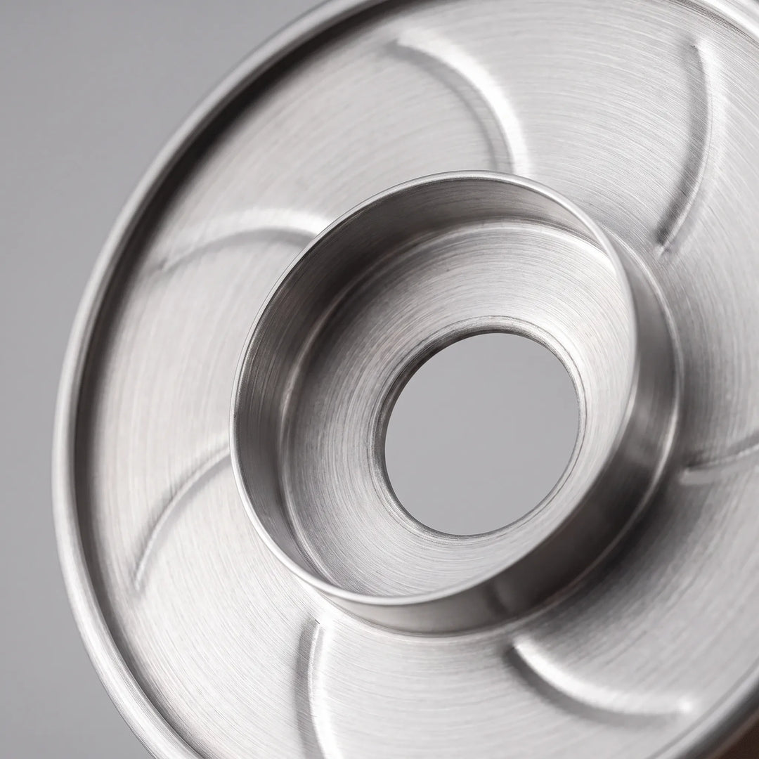 Elegant stainless steel ribbed pour-over coffee dripper, a modern beverage brewing gift idea.