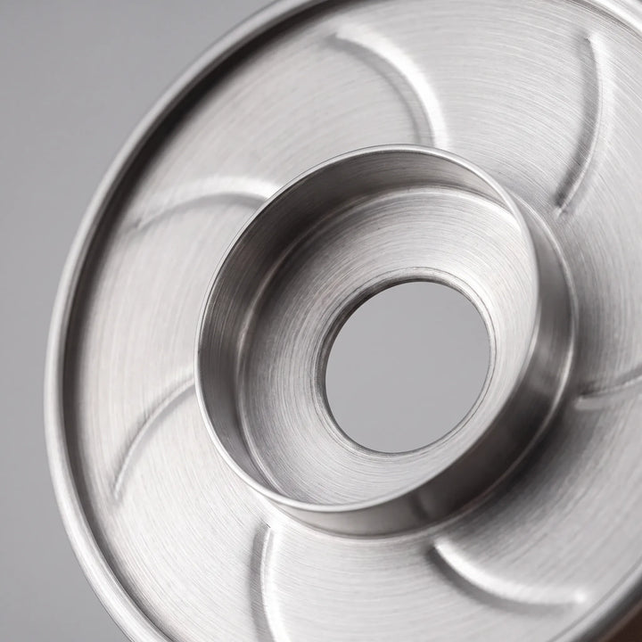 Elegant stainless steel ribbed pour-over coffee dripper, a modern beverage brewing gift idea.