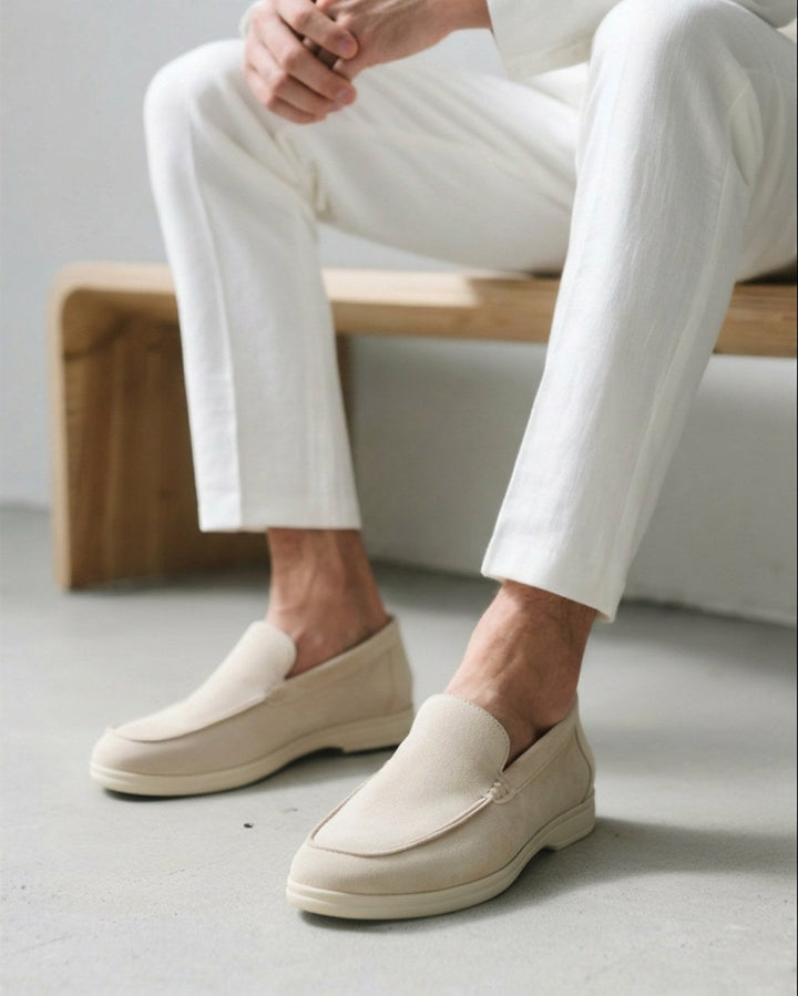 Men's slip-on loafers in brown, styled casually with jeans for a comfortable smart look.