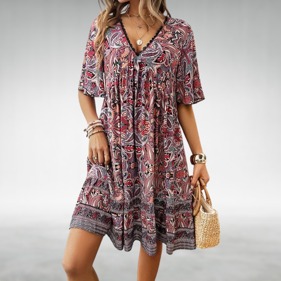 Printed women's boho swing dress, stylish paisley pattern, v-neck. Ideal for beach days & relaxed holiday wear.