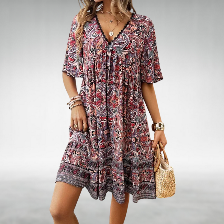 Printed women's boho swing dress, stylish paisley pattern, v-neck. Ideal for beach days & relaxed holiday wear.